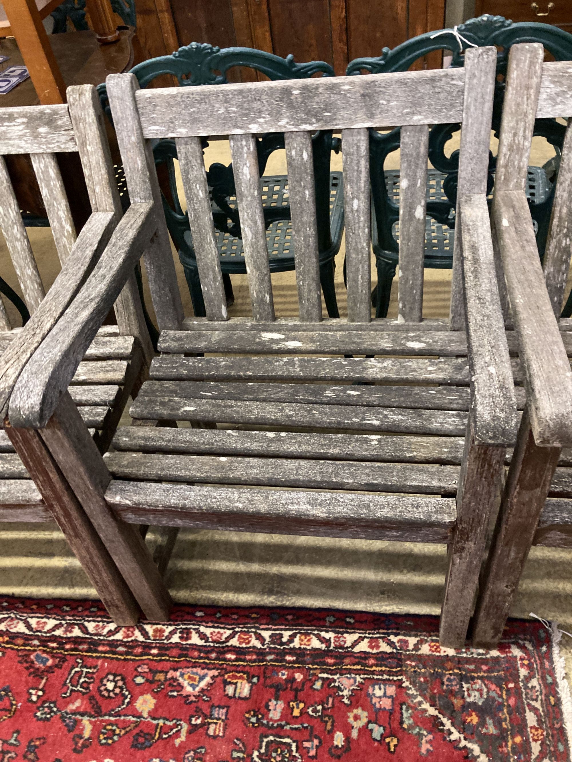 A set of six weathered teak elbow chairs, width 62cm, depth 58cm, height 85cm